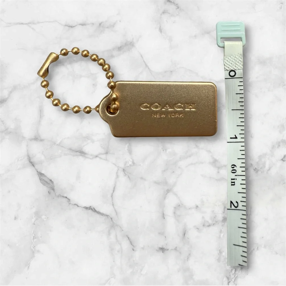 COACH Gold Tag Keychain - COACH New York Signature